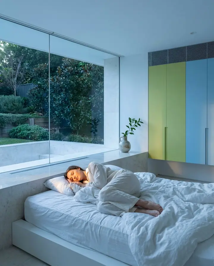 A calm bedroom at dawn with soft blue light
